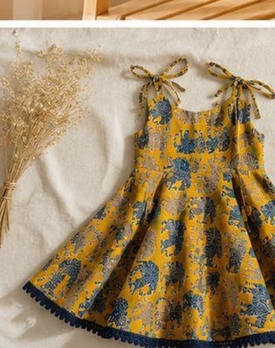 Mustard elephant print dress flat-lay